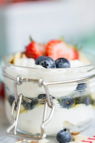 yogurt with berries on top in mason jar