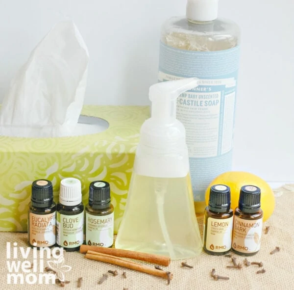 DIY foaming hand soap next to a box of tissues and some essential oils