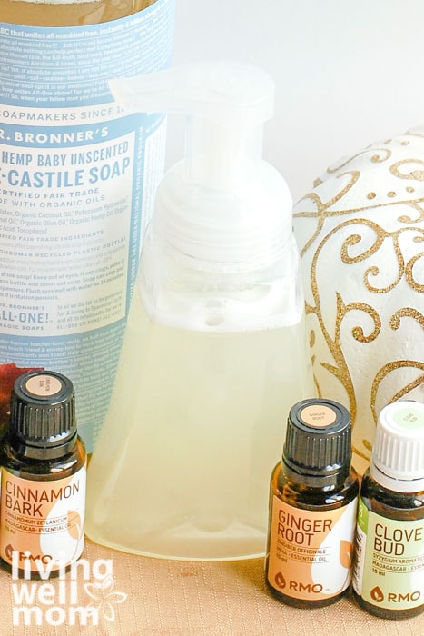 Foaming hand soap next to essential oils