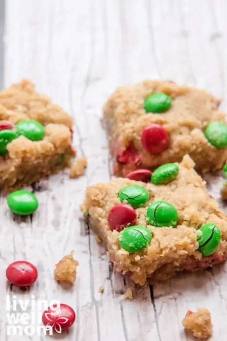 Cookie bars filled with caramel and green and red m&m's.