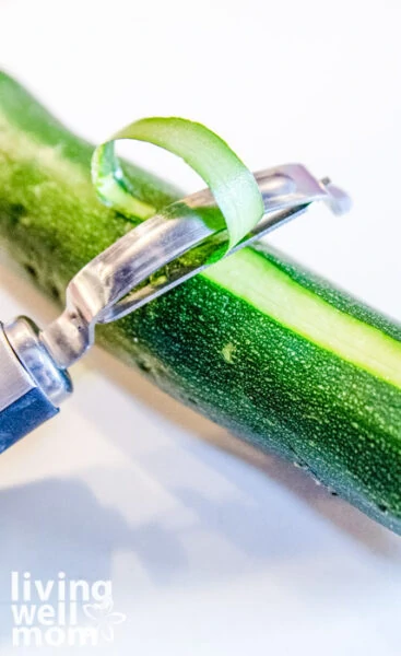 Peeling thin layers of zucchini to make zoodles