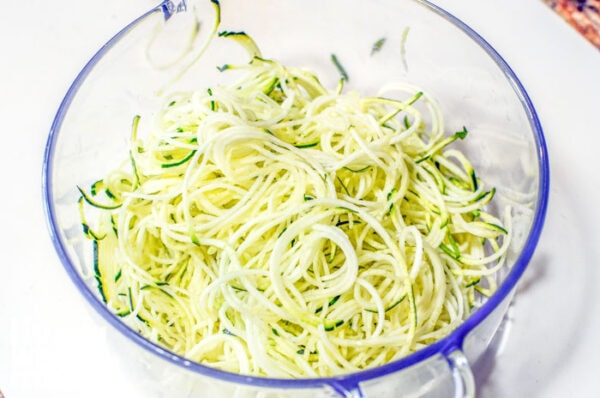 Glass bowl filled with zucchini noodles