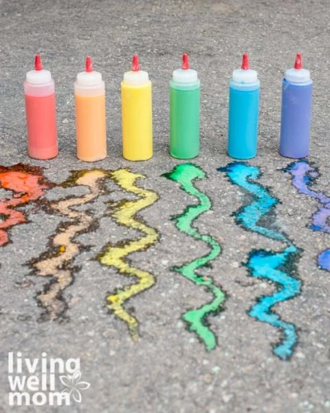 Sidewalk paint in red, orange, yellow, green, blue, and purple lined on concrete ground