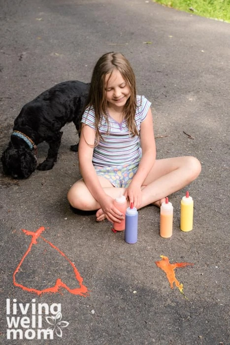 Young girl painting with homemade chalk paint