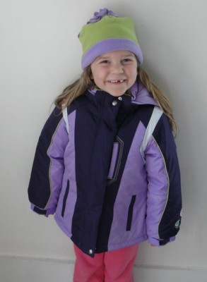 smiling happy girl wearing purple winter coat