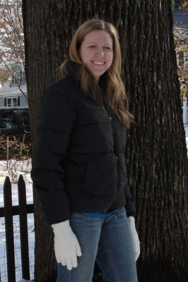 a woman wearing a plain black winter coat with no hood