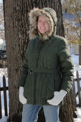 woman wearing green winter coat with fuzzy hood