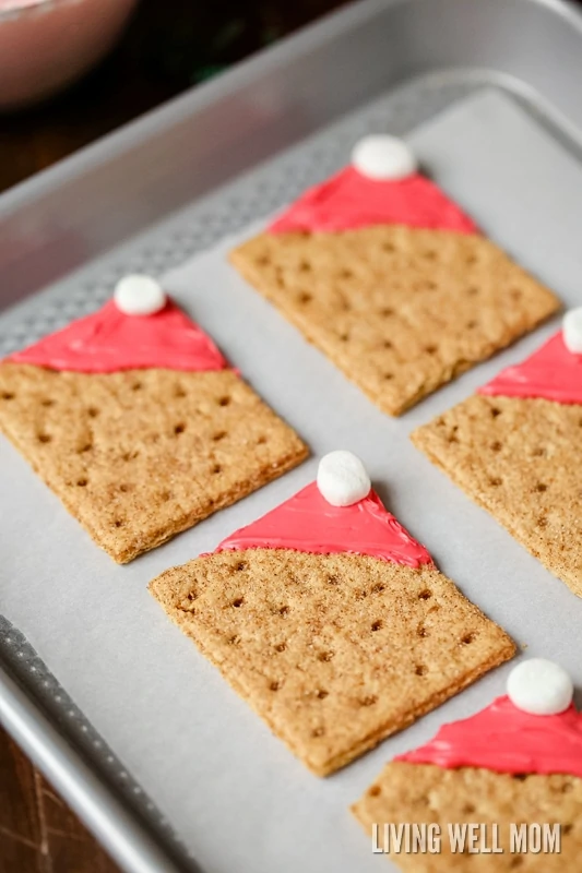 square gram crackers with red frosting on it and a marshmallow 