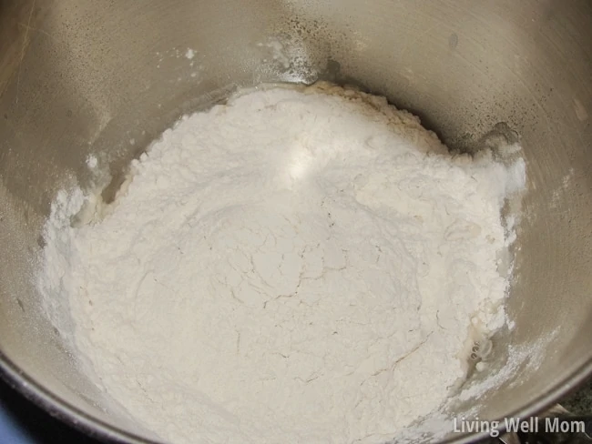 adding flour to the mixing bowl