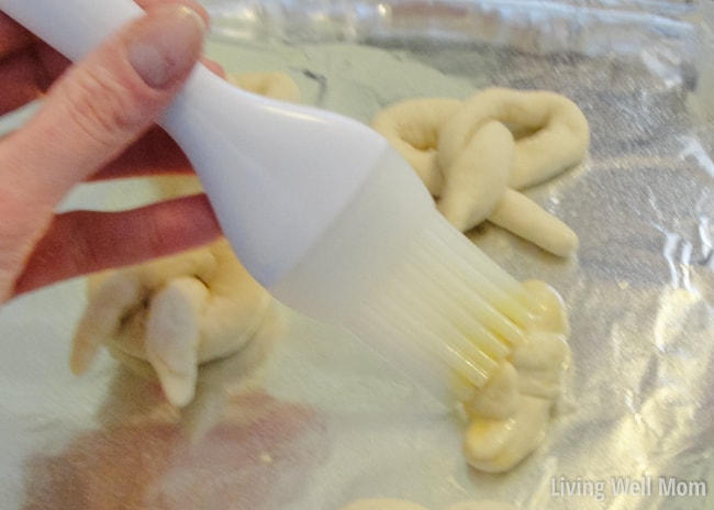 brushing egg mixture on soft pretzel recipe