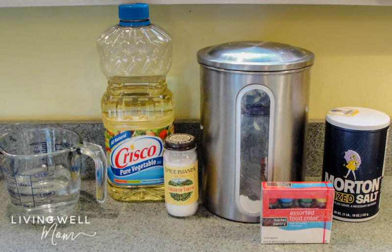 Ingredients for DIY playdough including vegetable oil, cream of tartar, flour, salt and food coloring. 