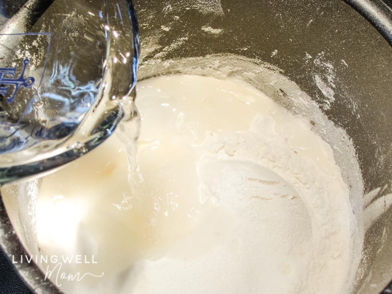 Adding water into dry ingredients for making homemade playdough.