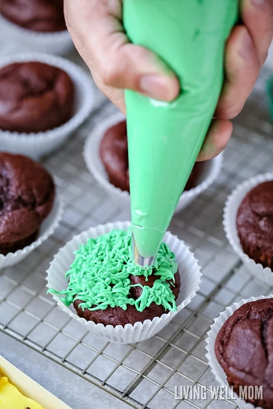 frosting being put on cupcakes