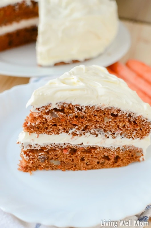 close up of slice of carrot cake on white plate
