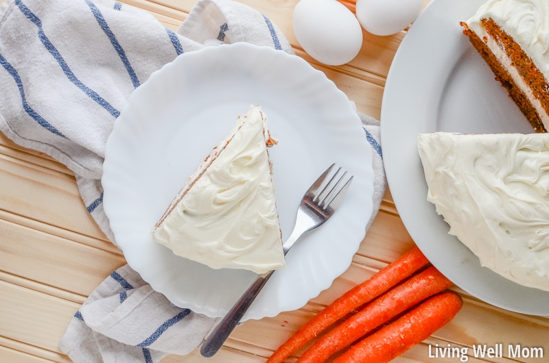looking down on slice of carrot cake on a white plate with fork