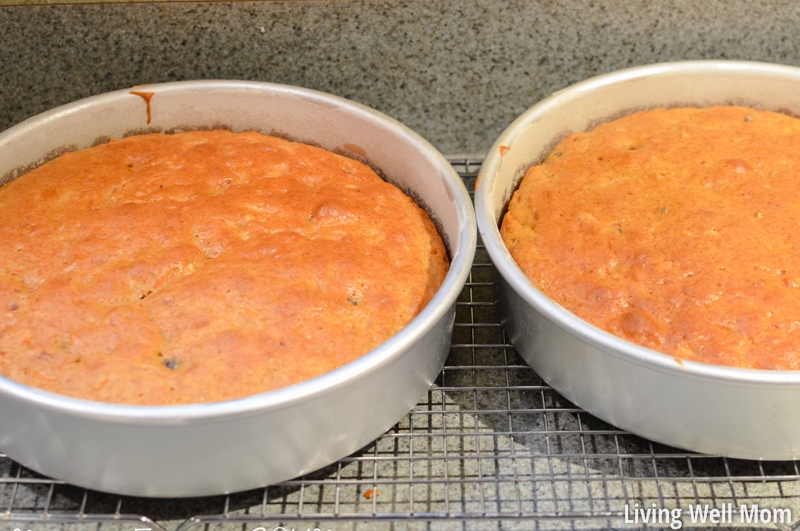 freshly baked carrot cake in cake pans cooling on wire racks