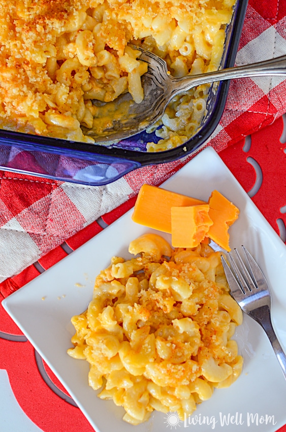 mac and cheese for kids on a white plate with red table background