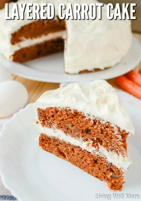 layered carrot cake with white cream cheese frosting on a plate