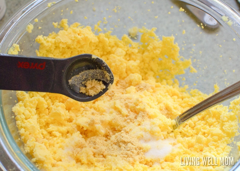 adding spices to crumbled hard boiled yolks