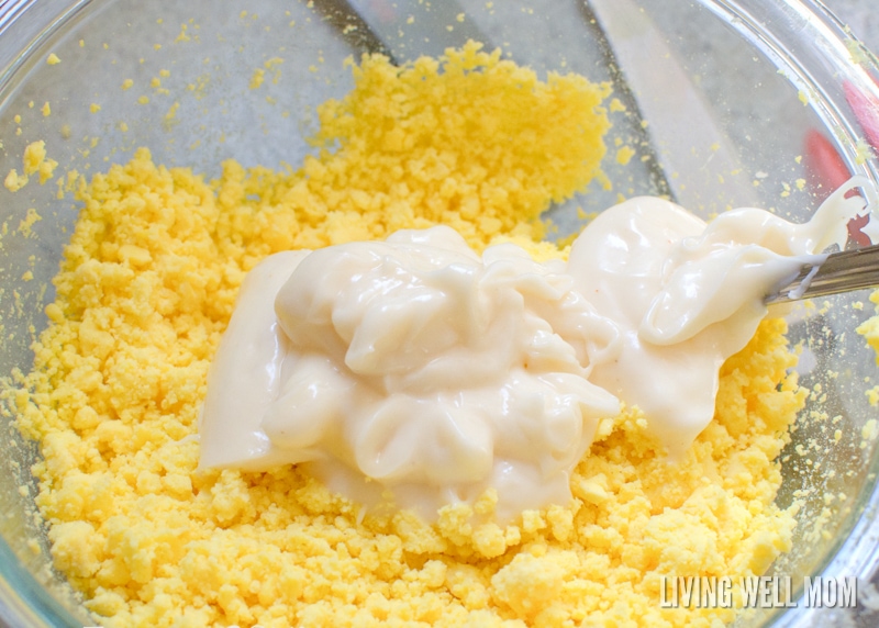 adding mayonnaise to crumbled egg yolk mixture for deviled eggs