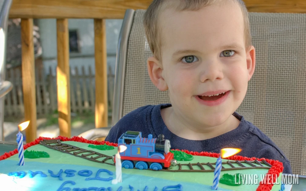 little boy with Thomas the Tank engine birthday cake
