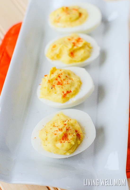 line of deviled eggs on a white plate