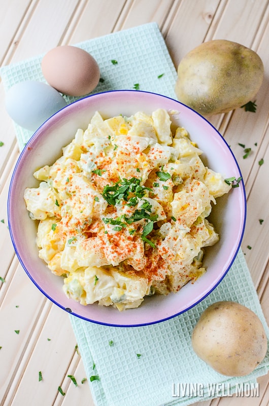 homemade potato salad in a bowl with potatoes and eggs on the side