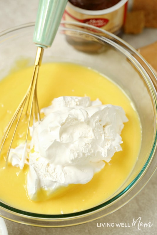 stirring whipped cream into vanilla pudding