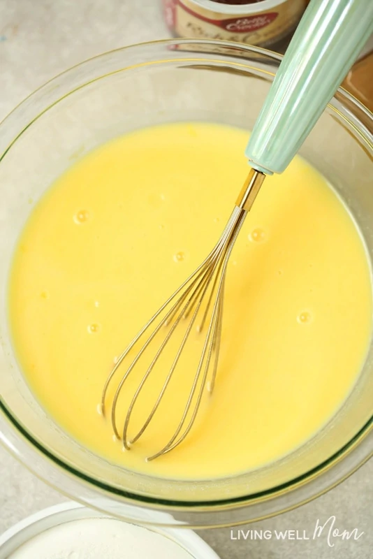 whisking vanilla pudding mix in bowl with milk
