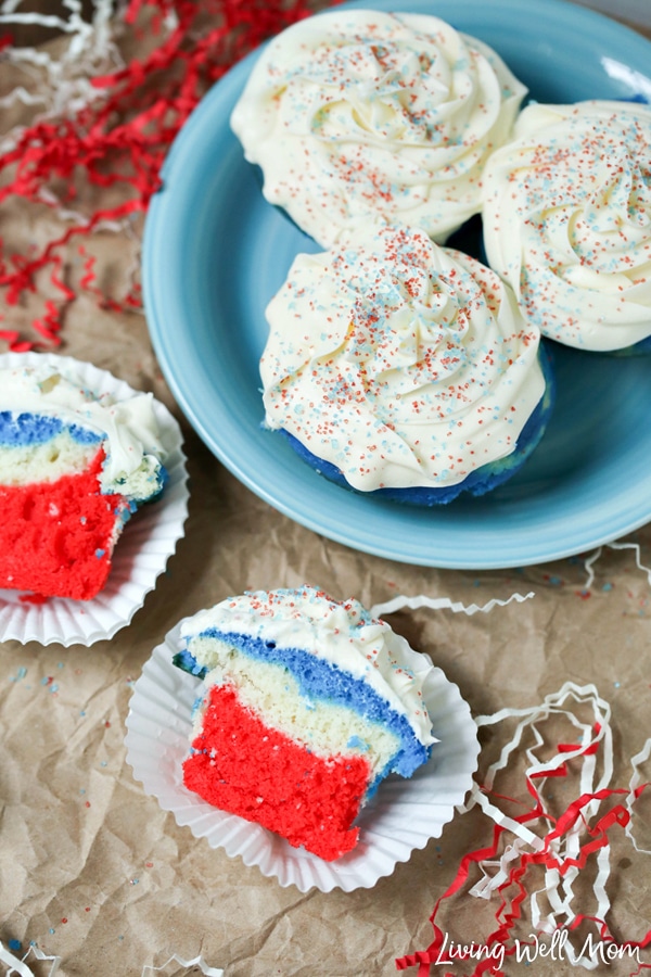red white blue patriotic cupcake split in half on wrapper with more cupcakes on plate