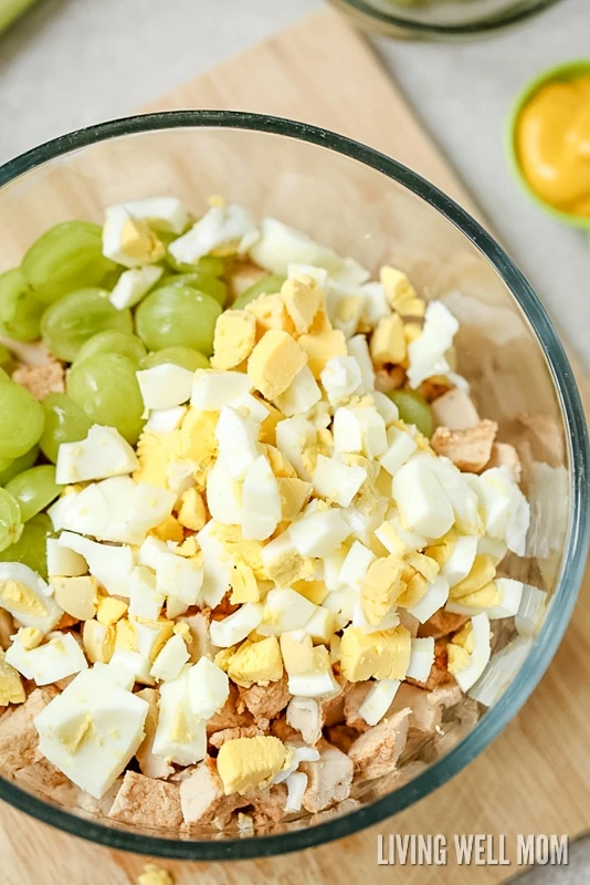 This delicious Almond Chicken Salad has slivered almonds, grapes, celery, and hard-boiled eggs tossed with cooked chicken and combined with mayo, sour cream, and seasoning. It's perfect for a delicious lunch or even enjoyed as supper on a hot summer day.