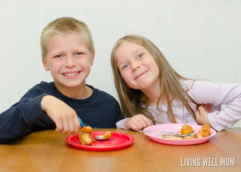 a little boy and girl eating apple monkey bread bites 