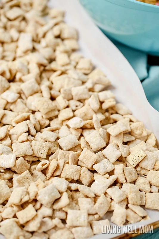 puppy chow spread onto a cookie sheet to dry