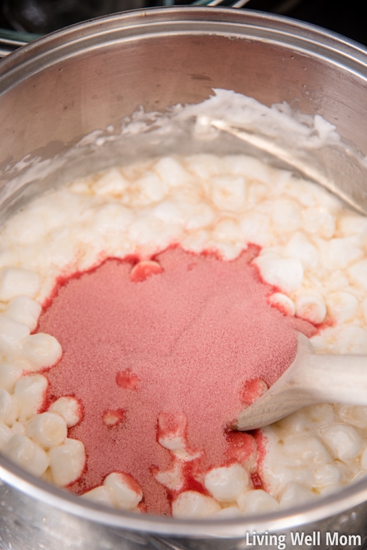 Adding strawberry gelatin to the melted marshmallows