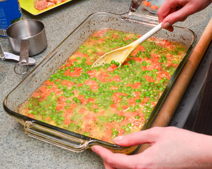 stirring peas carrots casserole