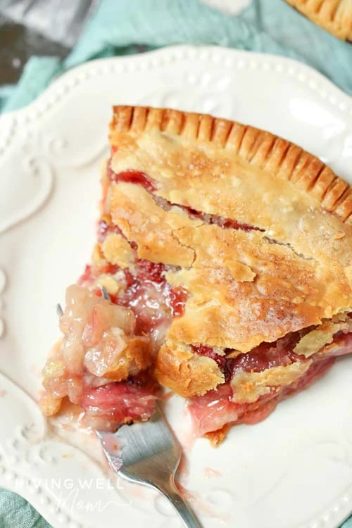 strawberry rhubarb pie on a plate with a fork