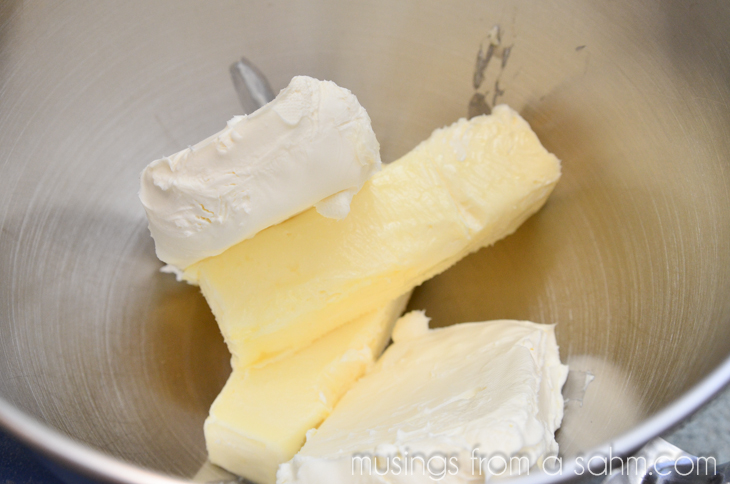 Butter and cream cheese in a stainless steel mixing bowl. 
