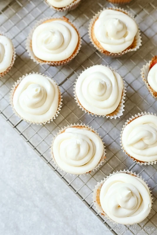 Freshly baked cupcakes topped with a swirl of cheesecake icing. 