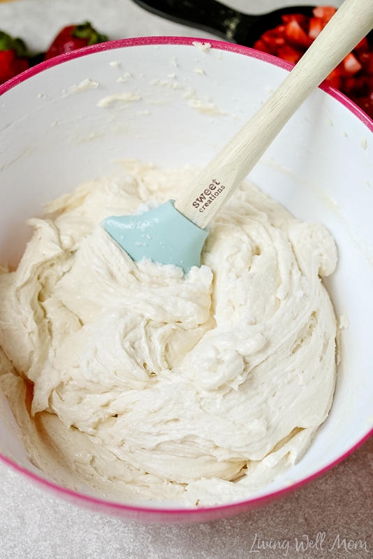 Remaining ingredients added into the  mixing bowl for strawberry cheesecake cupcakes.  