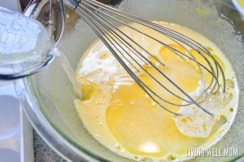 whisking lemon juice, oil and water for homemade cake recipe