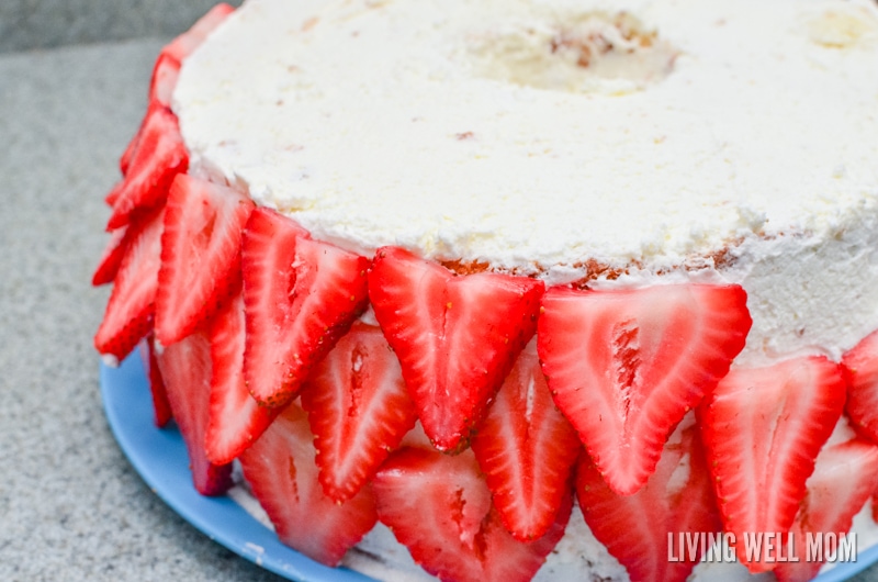 fresh strawberry slices covering the outer edge of a homemade cake 