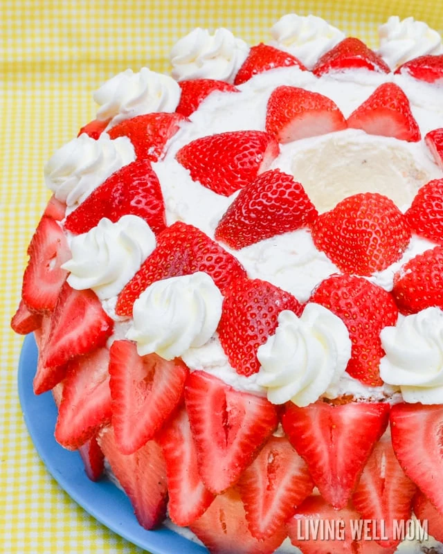 a made from scratch cake with fresh strawberries and whipped cream 