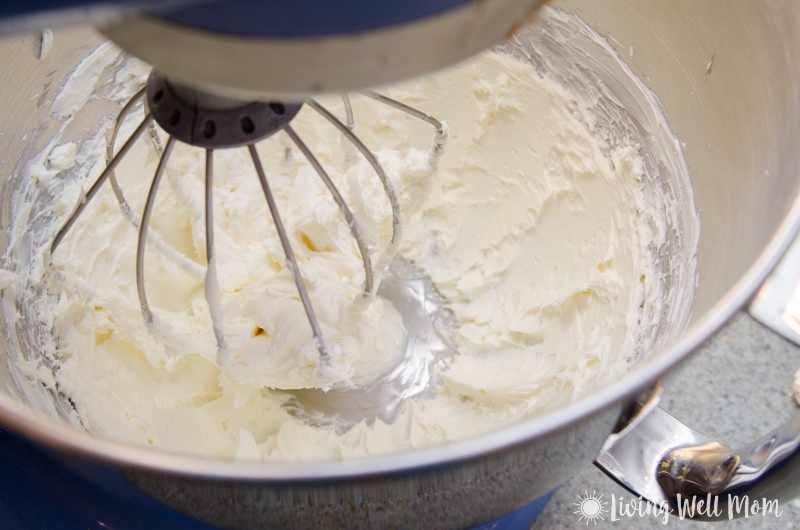 Stand mixer mixing a cream cheese filling for a pumpkin spice roll recipe