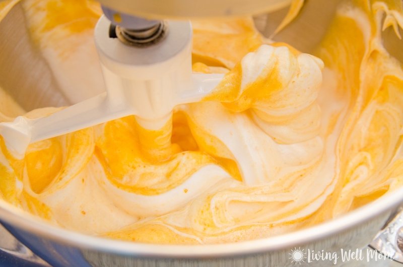 Swirling together pumpkin cake batter with stiff whipped egg whites