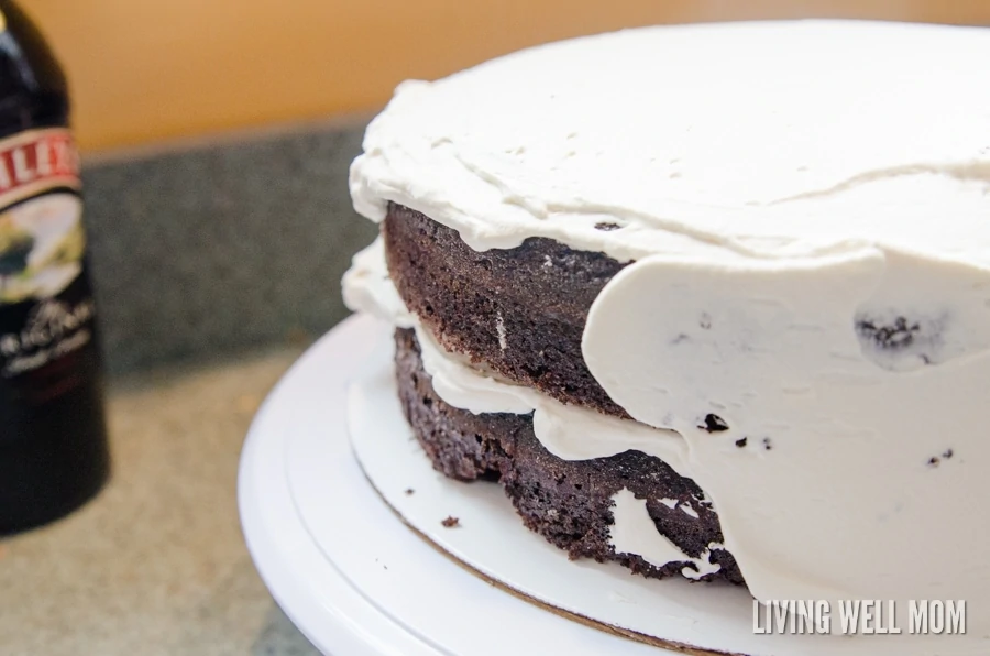 Adding frosting to the chocolate irish cream cake 
