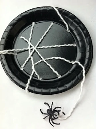 DIY spiderweb made out of a painted plate and string