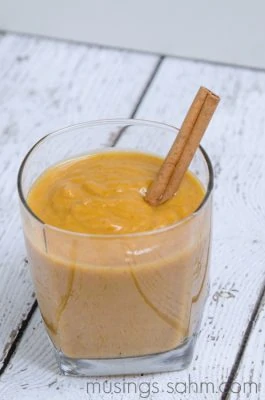 pumpkin smoothie in glass with cinnamon stick