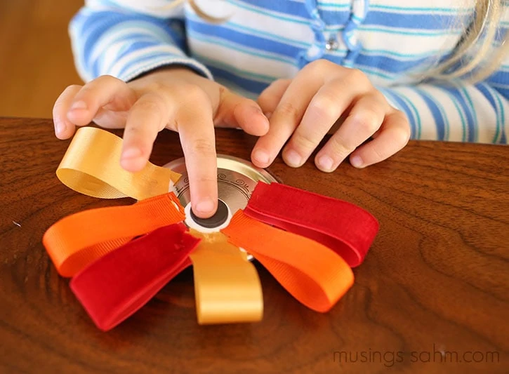 This adorable Canning Jar Lid Turkey Magnet is a fun easy Thanksgiving craft for kids that they'll love putting together and you'll love displaying! They also make great gifts!