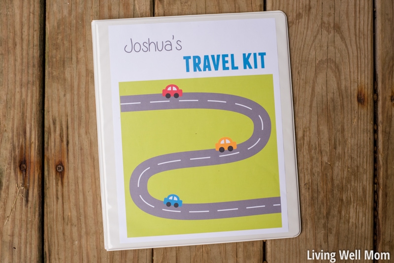 DIY Travel Binder Kit for kids on a wooden surface with customized cover.