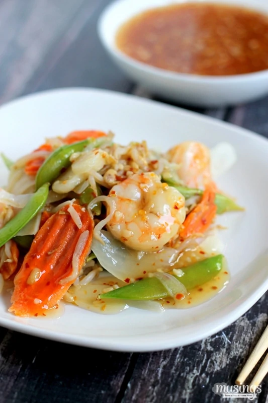 Treat yourself to this tasty Sweet Chili Asian Shrimp Stir Fry recipe for a quick and easy, healthy dinner. You'll love the flavorful honey sauce (there's no sugar!) combined with vegetables and shrimp. Yum!